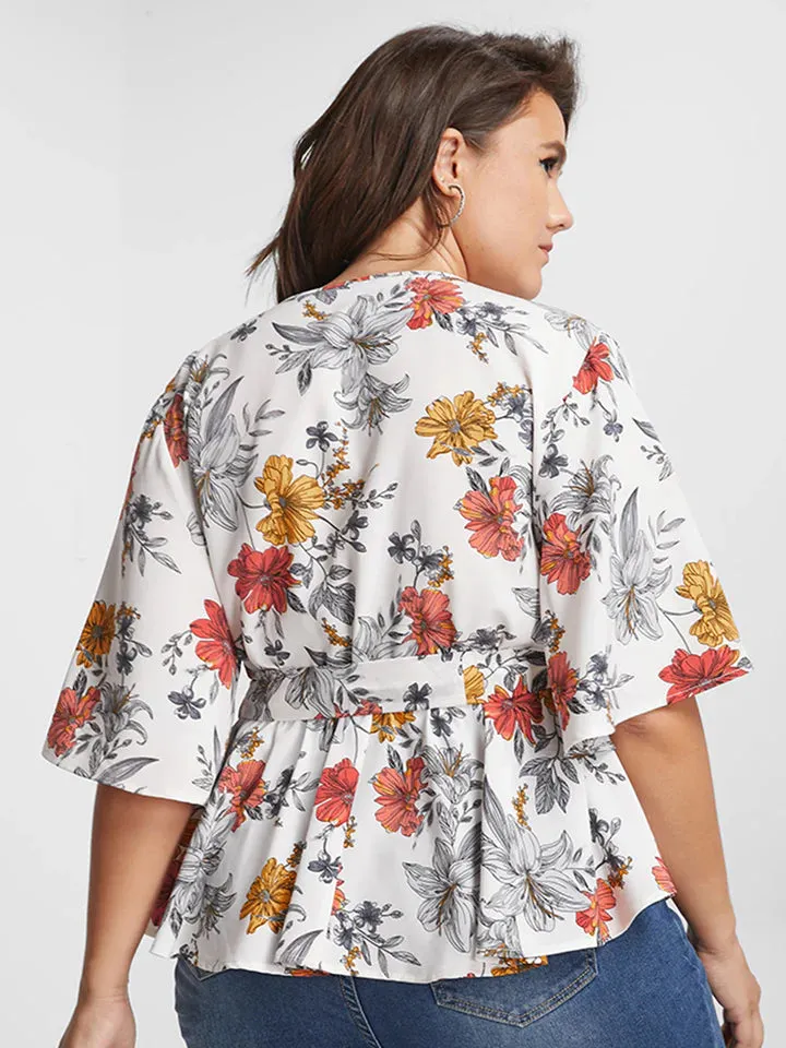 BLOOMCHIC WRAP STYLE BELTED V NECK WITH FLORAL DESIGN ON SOLID COLOR BACKGROUND