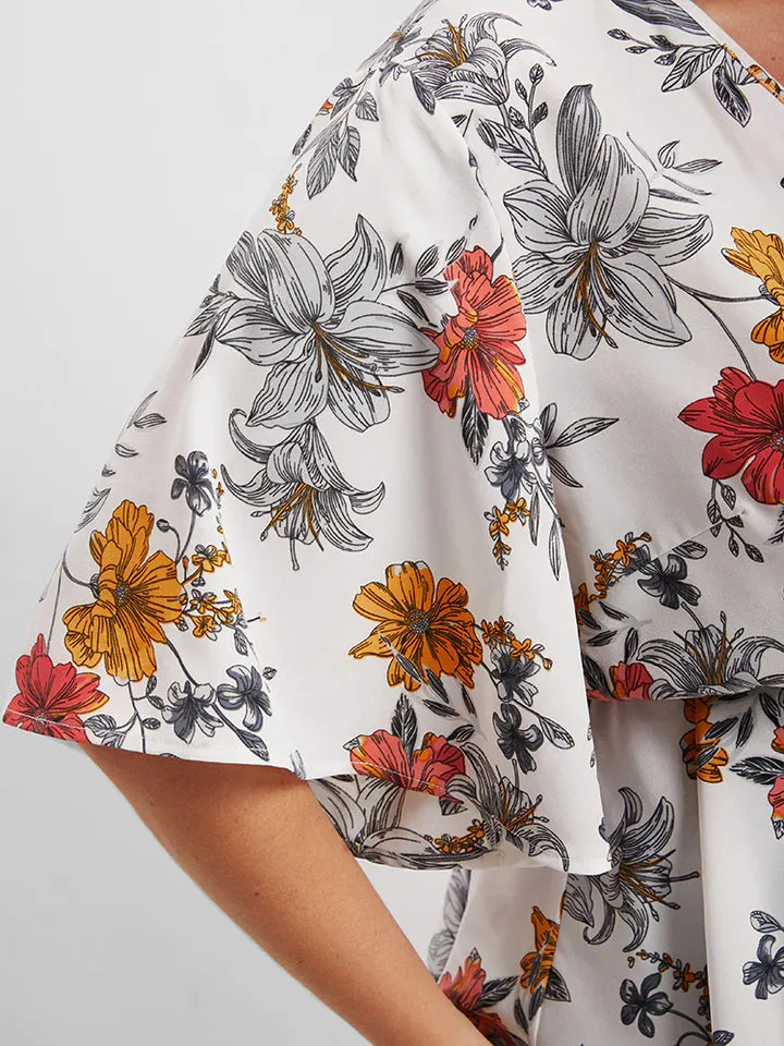 BLOOMCHIC WRAP STYLE BELTED V NECK WITH FLORAL DESIGN ON SOLID COLOR BACKGROUND